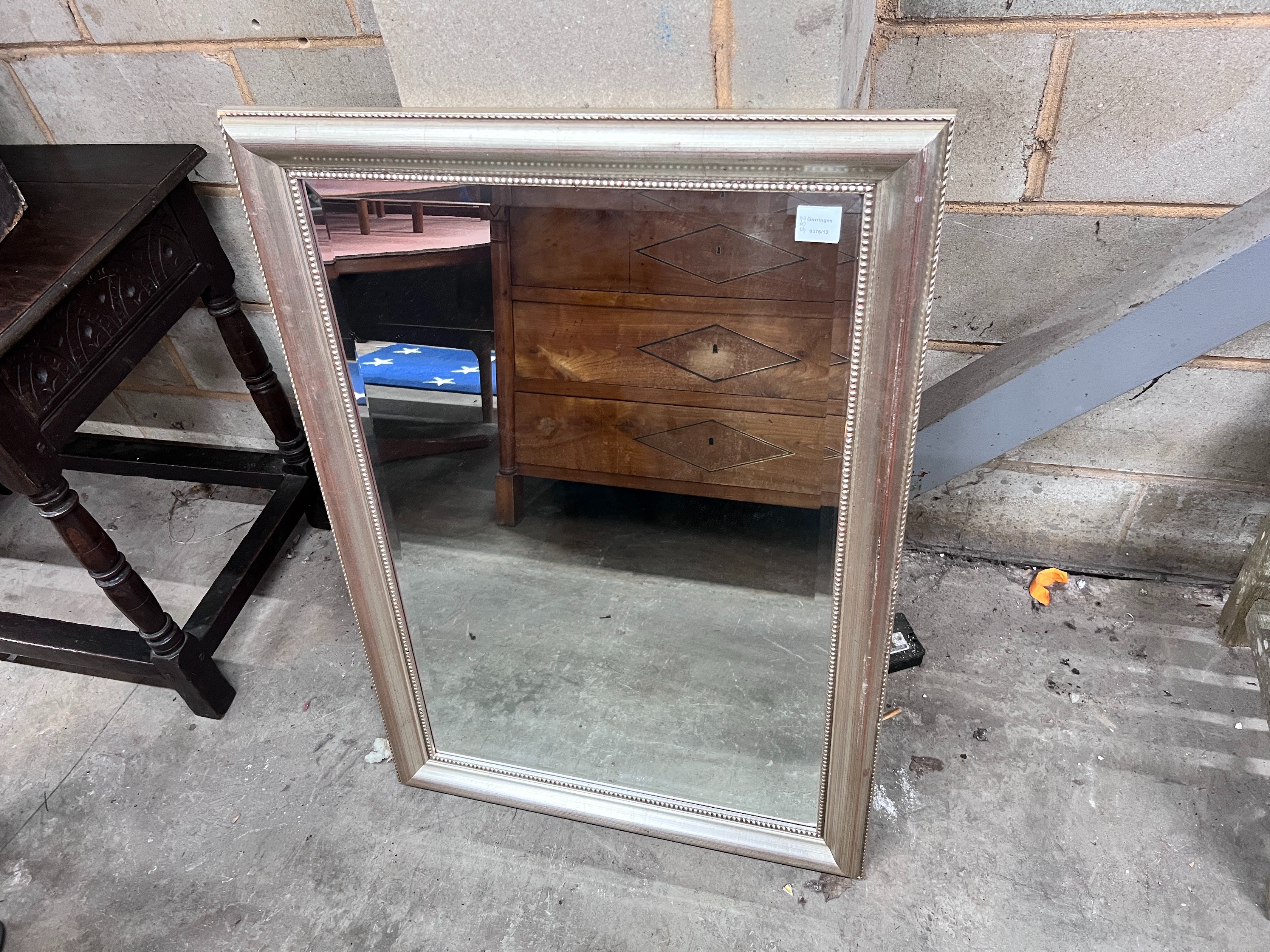A silvered wood framed wall mirror, width 74cm, height 105cm *Please note the sale commences at 9am.